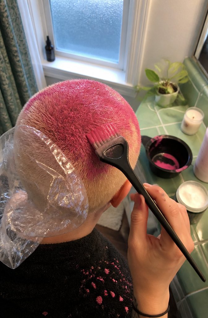 Fashion dye brushed across a short buzz cut beside a shower cap