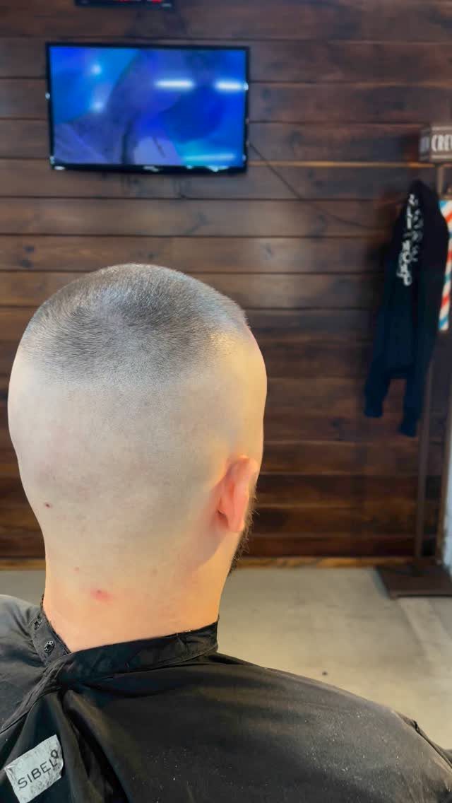 Man with a high and tight buzz cut fade seen from behind.