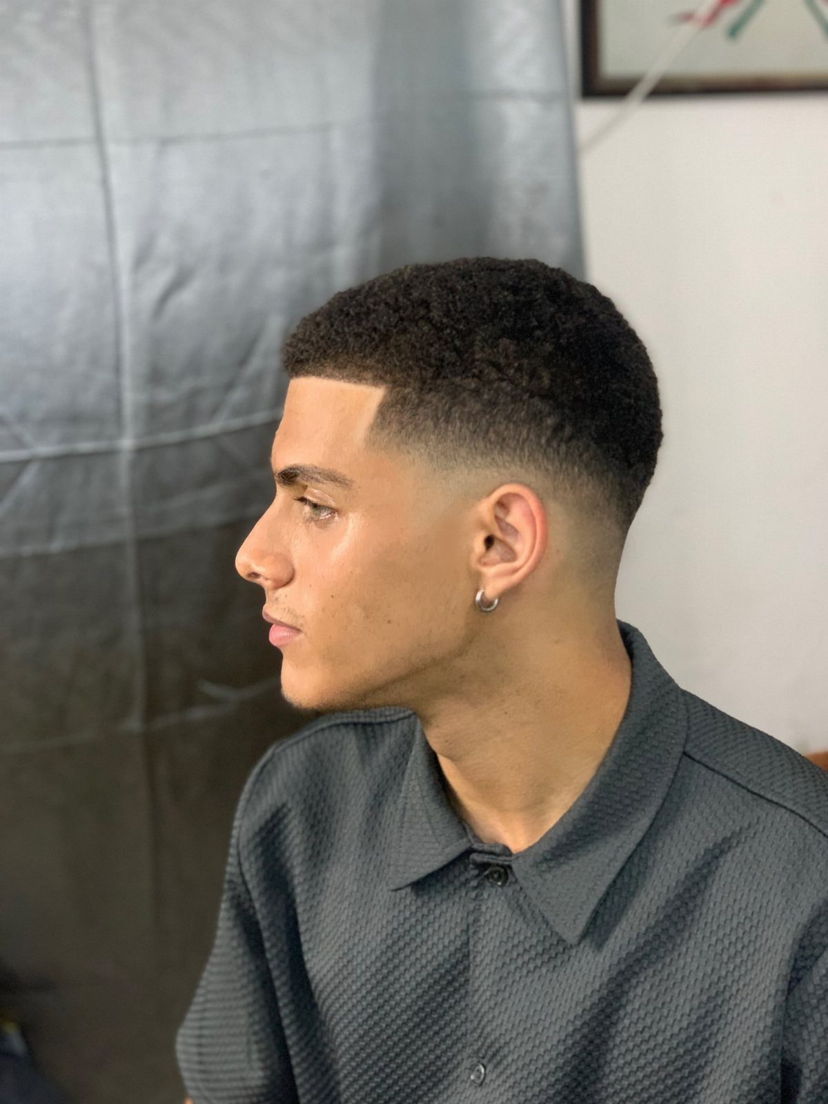 Man with a very short buzz cut and a clean skin fade haircut.