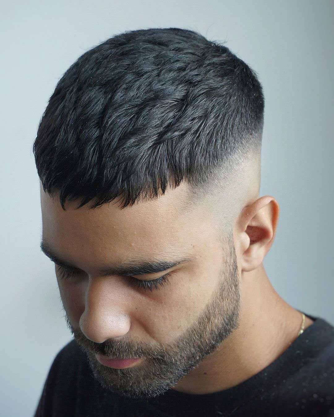 Man with a Caesar cut featuring short horizontal bangs and a skin fade.