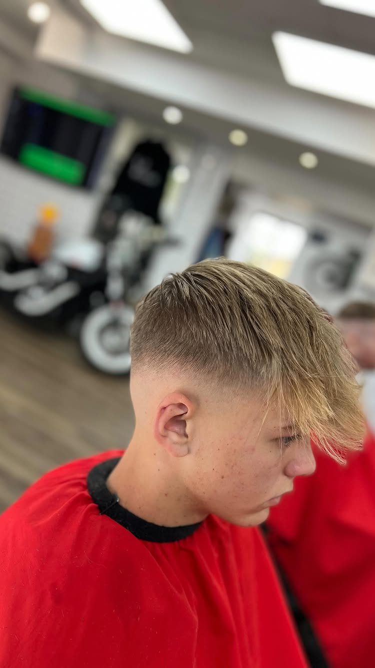Young man with a side swept fringe and faded sides in a barbershop