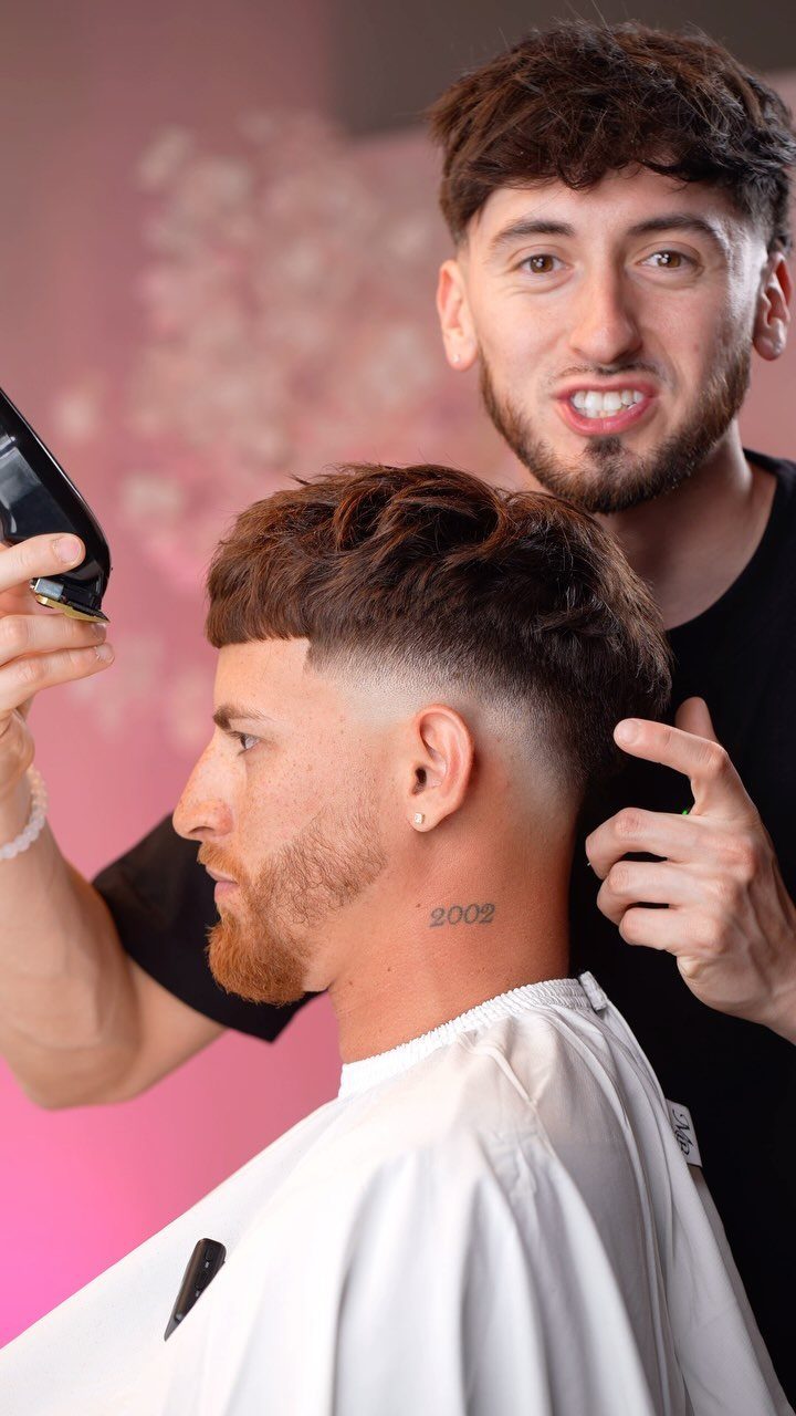 Man with a textured crop haircut and skin fade at a barbershop