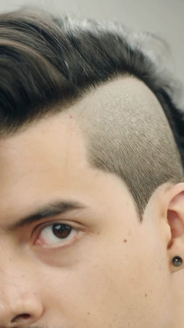 Man with an undercut haircut featuring long top and shaved sides.