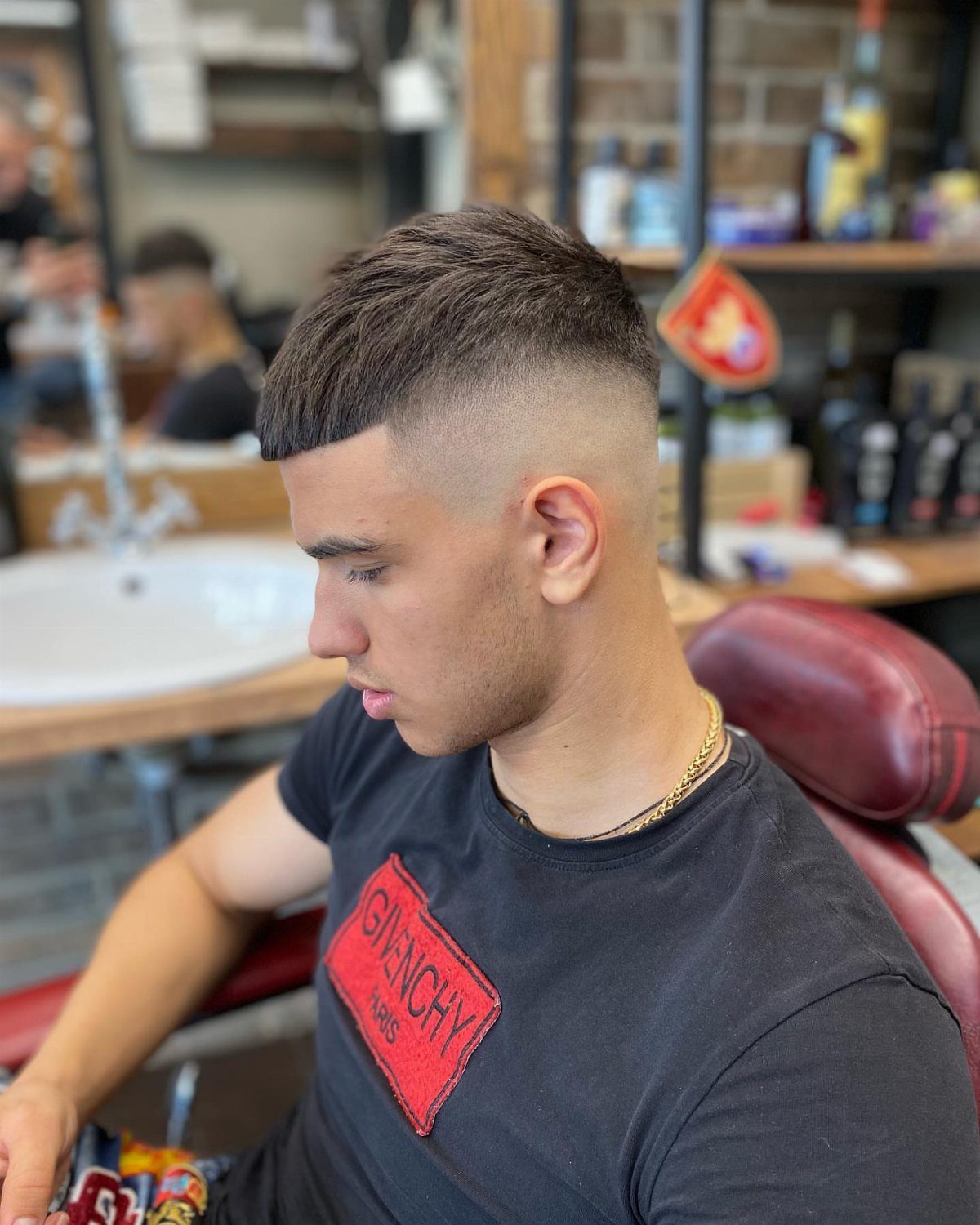 Man with a high fade French crop haircut featuring a straight forward fringe.