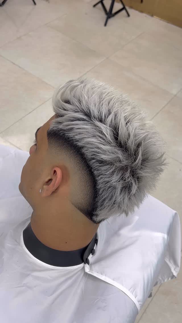 Man with silver-grey textured hair and a sharp high fade haircut side profile