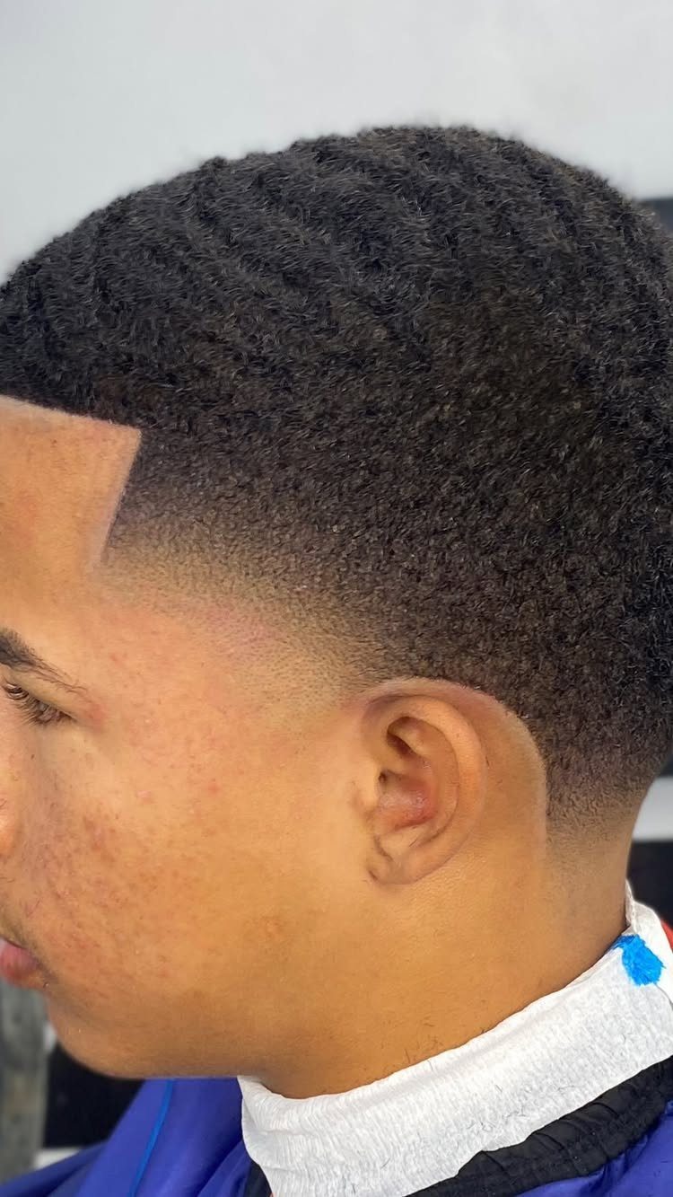 Man with 360 waves and a high taper fade haircut side profile