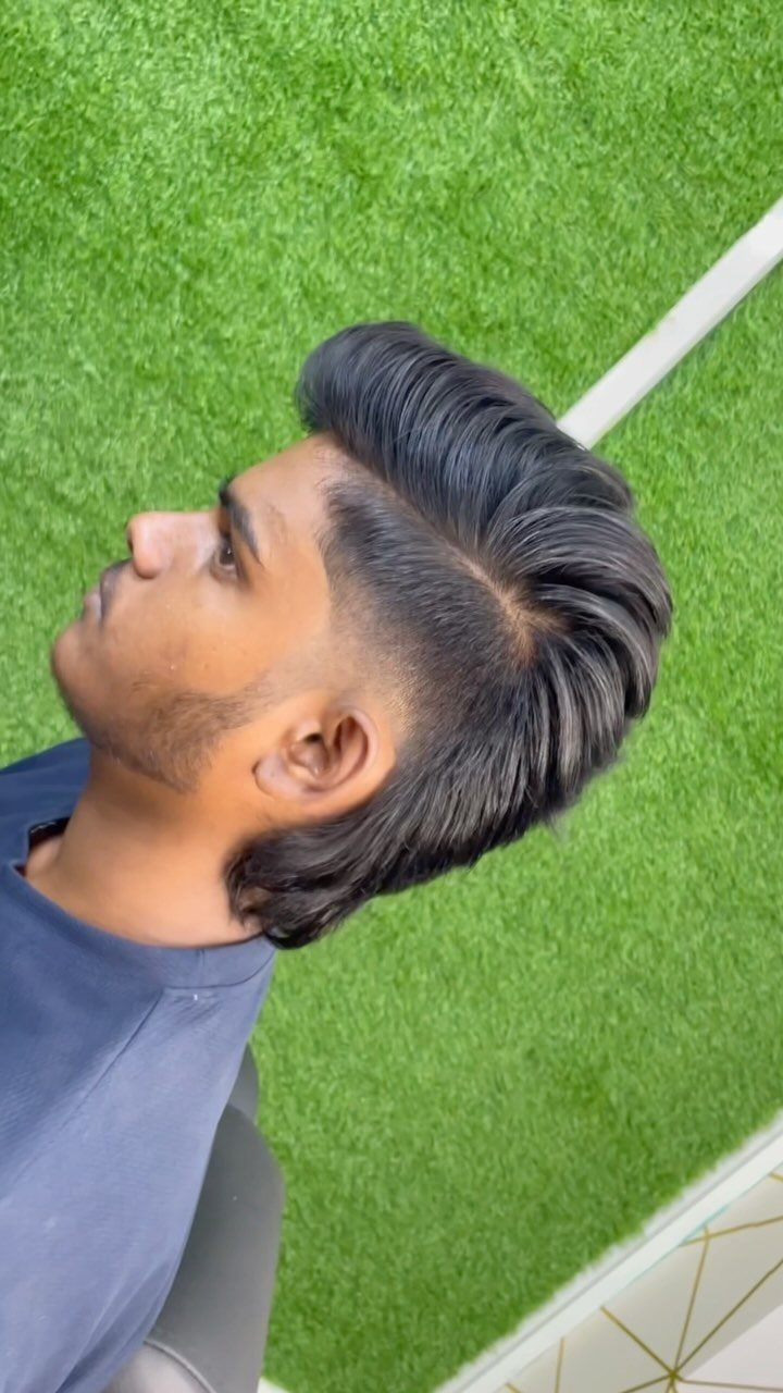 Man with a modern mullet hairstyle featuring faded sides and long back hair.