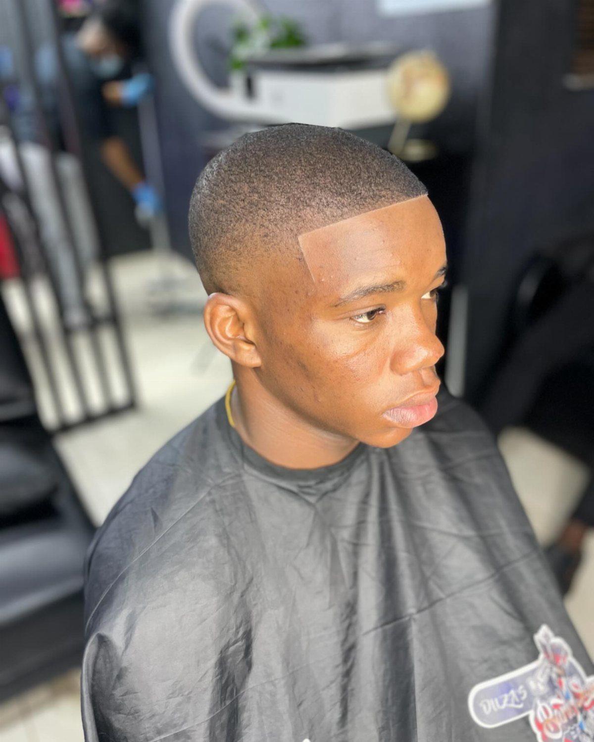 Man with a short buzz cut and a clean low skin fade haircut.