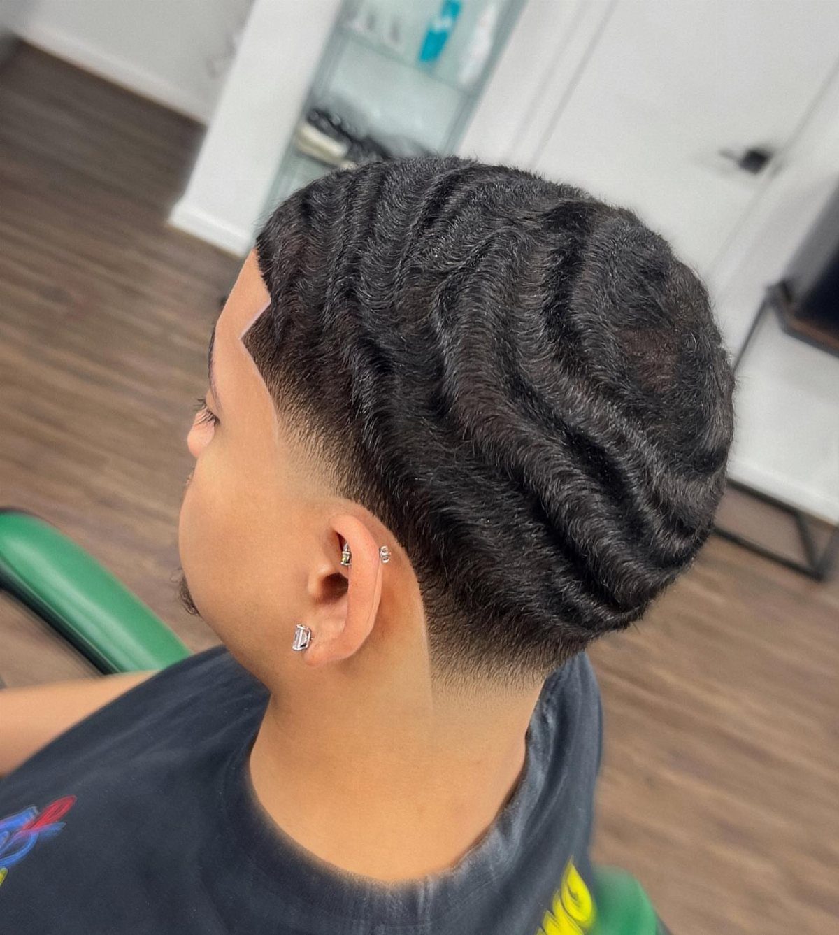Man with deep 360 waves on top and a clean low taper fade