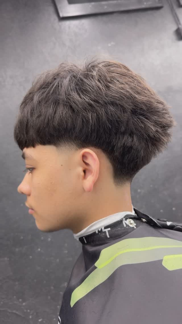 Young man with a low taper fade Edgar haircut and straight fringe.