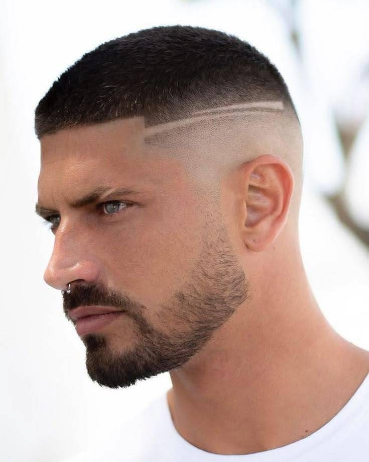 Man with a buzz cut, high skin fade, and shaved side lines.