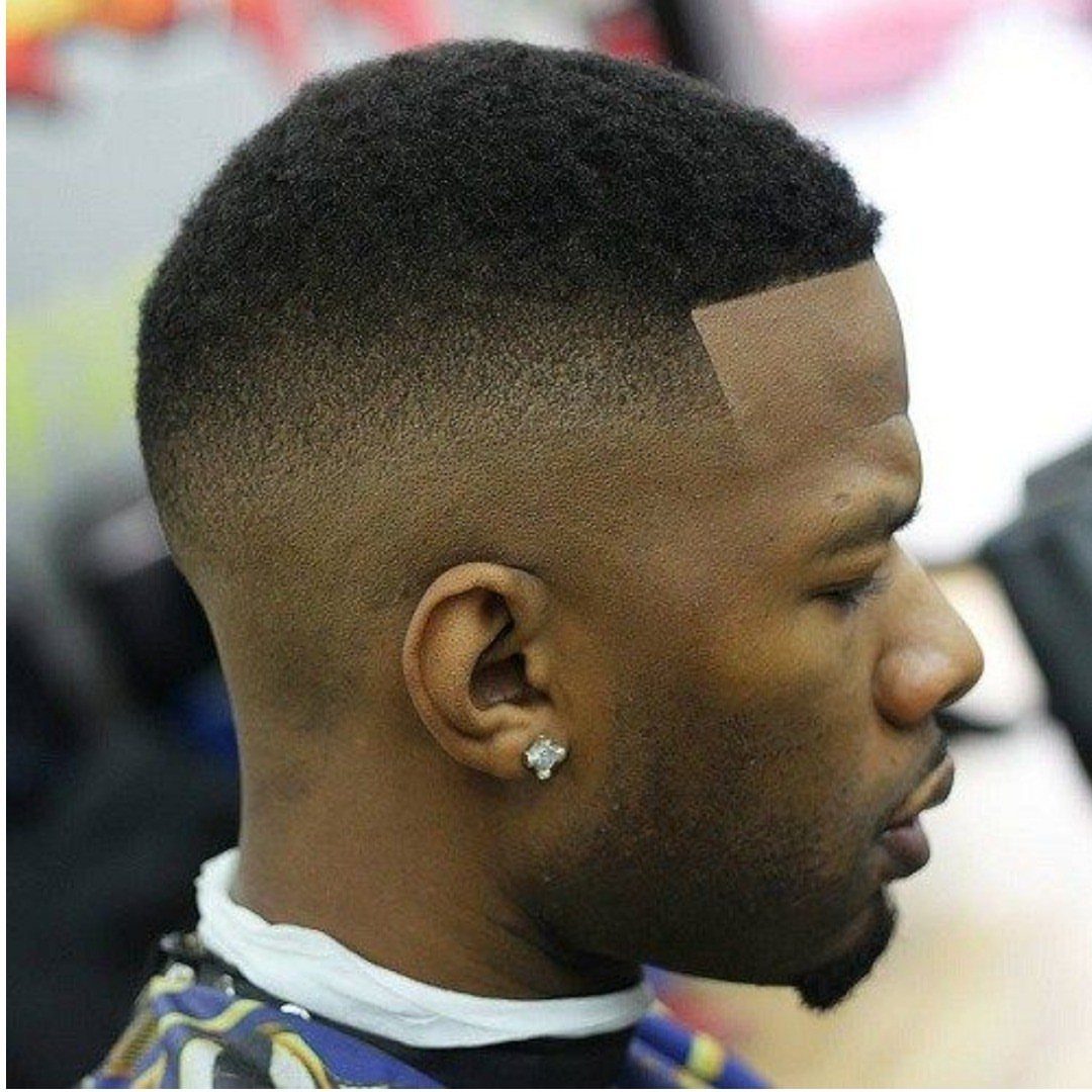 Black man with a short buzz cut and a clean skin fade.