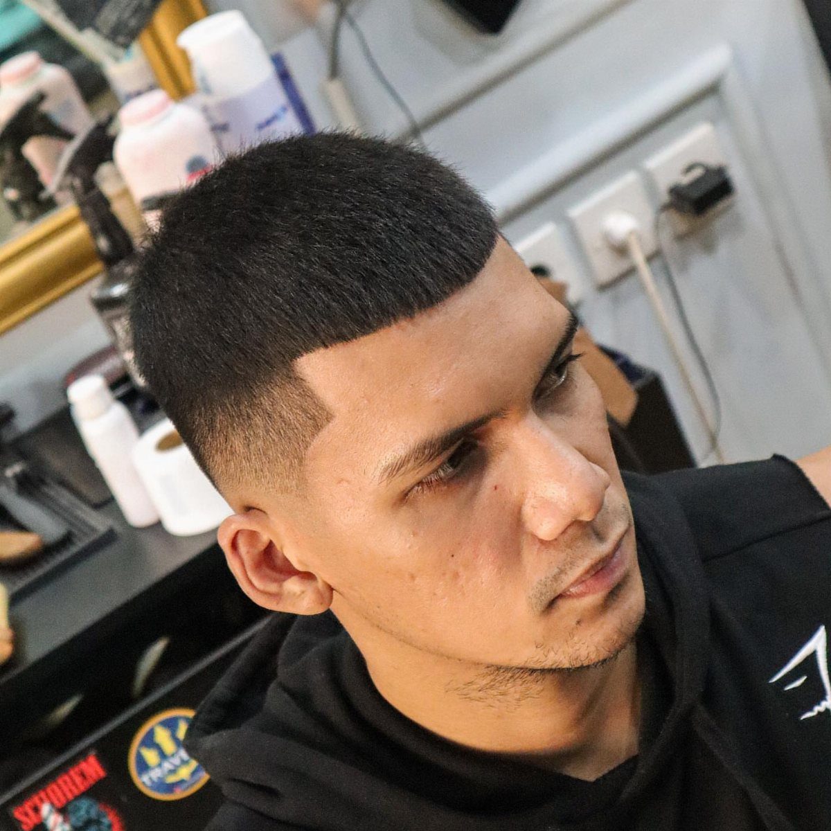 Man with a short Caesar cut featuring a straight fringe and faded sides.
