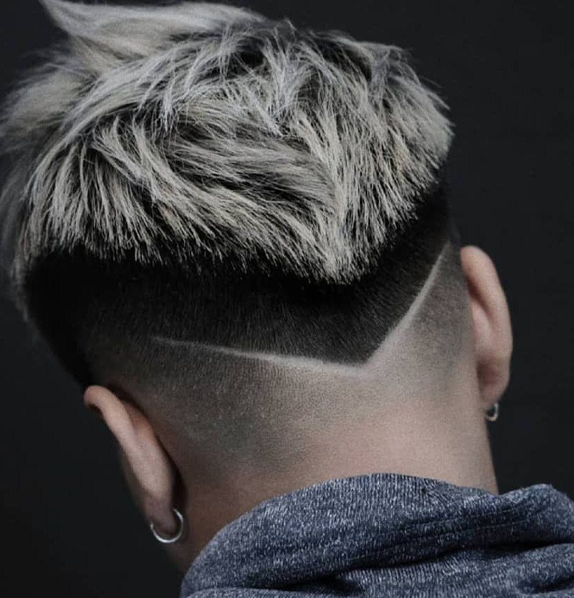 Man's haircut with bleached blonde top and a V-shaped fade at the neckline.