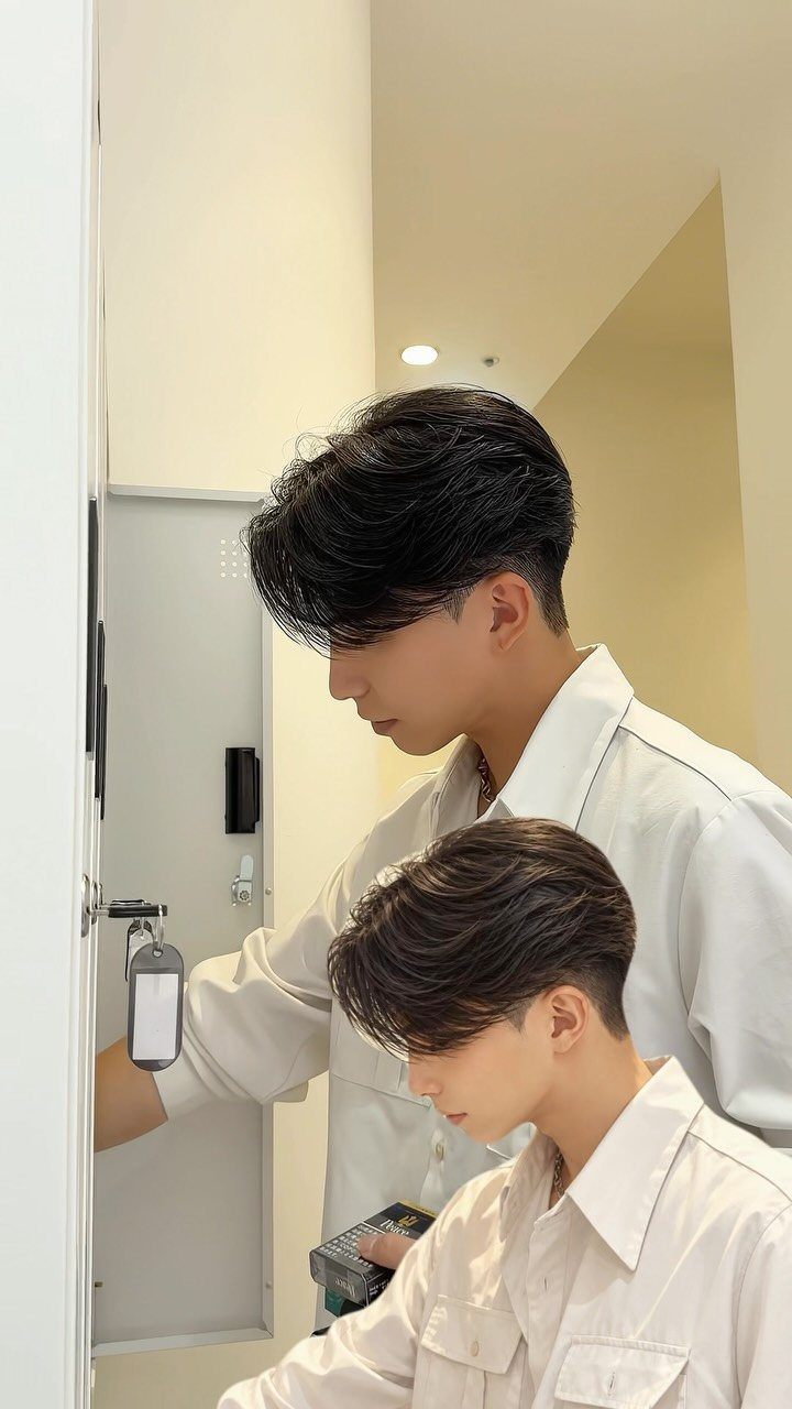 Young man with a two-block haircut and white shirt in a side profile