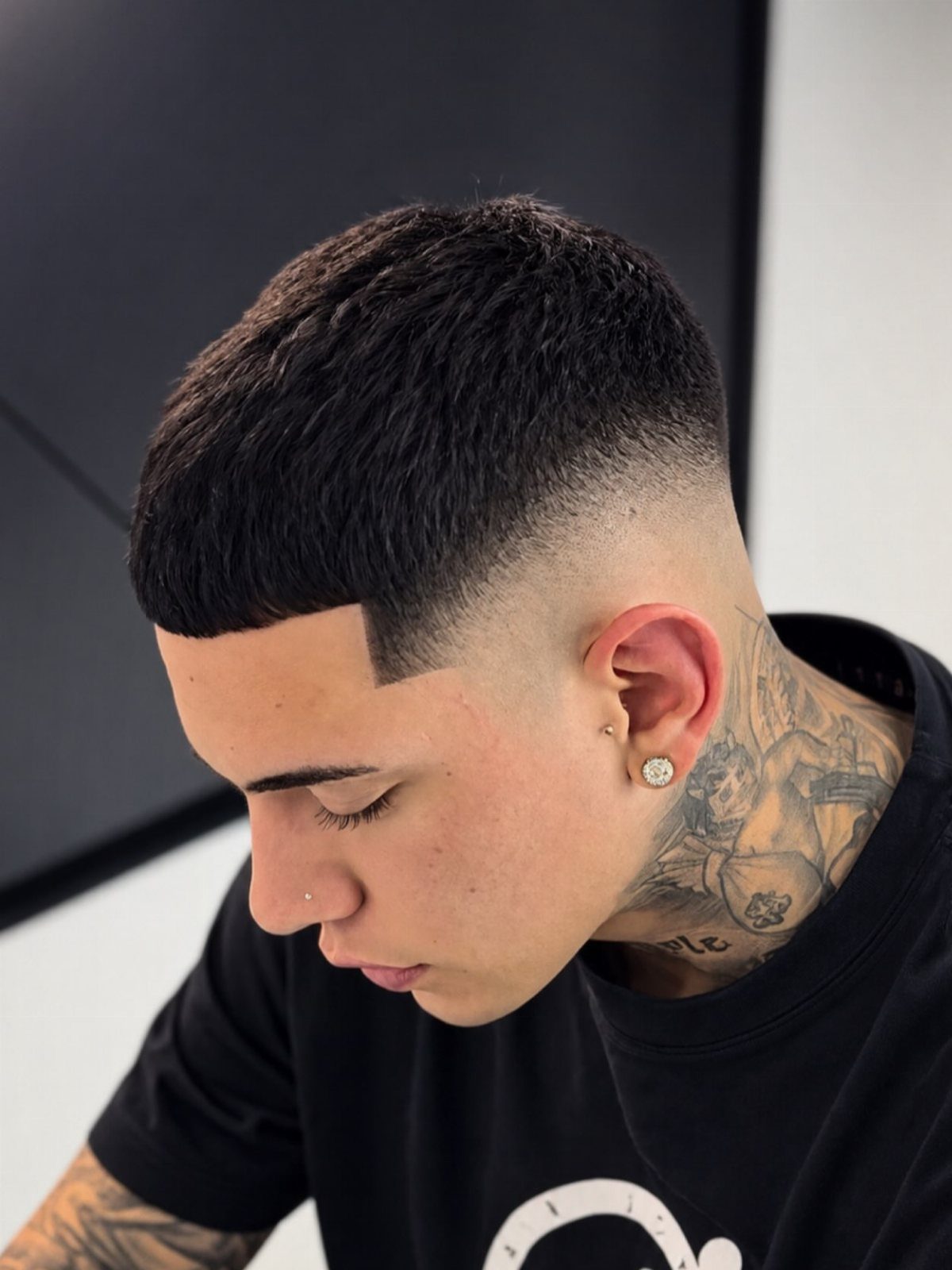 Man with an Edgar haircut featuring a straight fringe and high skin fade.