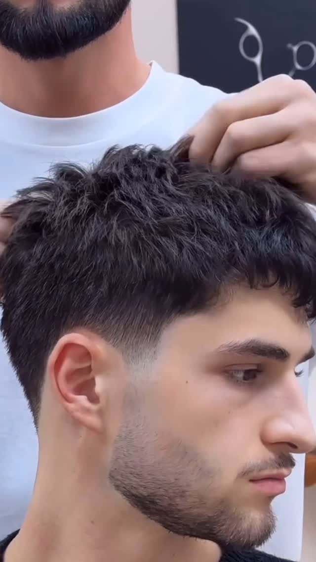 Man with a textured crop haircut and skin fade in a barbershop