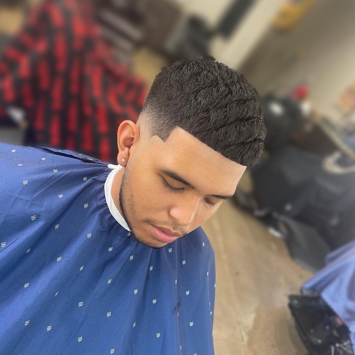 Man with a mid fade haircut and textured crop top with straight fringe.
