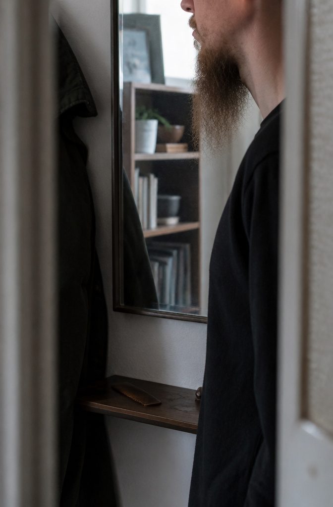 Man in ordinary clothes with a long narrow beard and thin cheek growth
