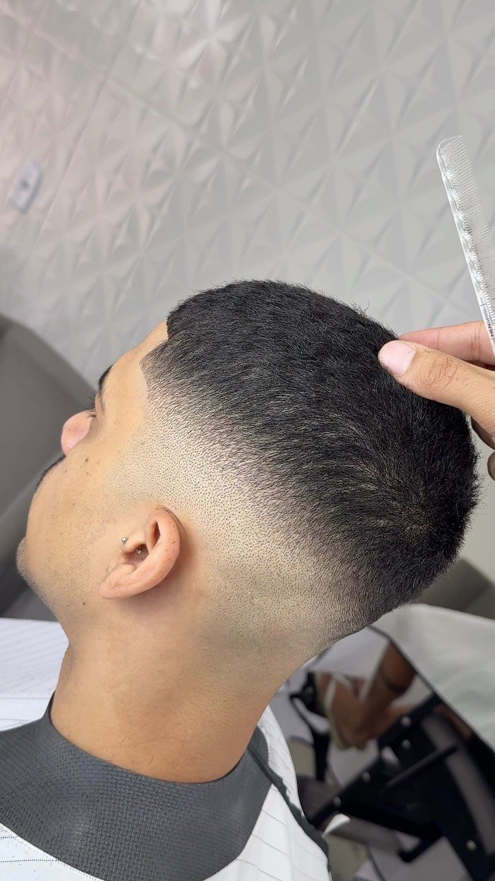 Man with a high taper fade haircut showing a clean blend on the side.